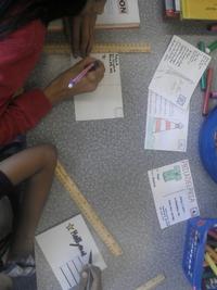 Children make travel postcards at Roxborough Library.